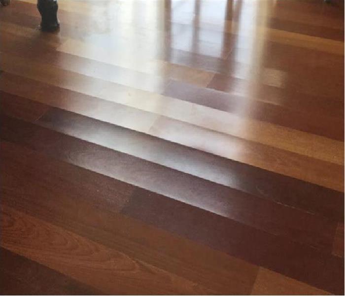 Hardwood flooring showing signs of warping