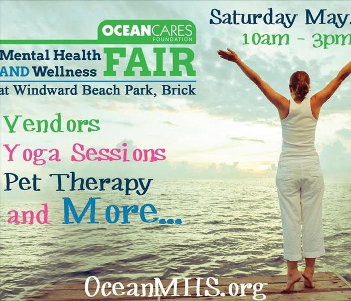 A woman near beach flyer says free yoga sessions/pet therapy & more