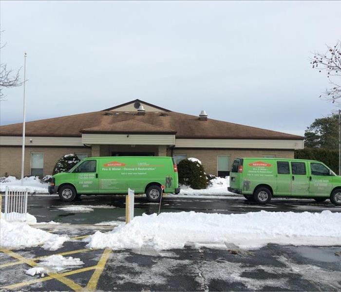 tan building and a parking lot covered in snow