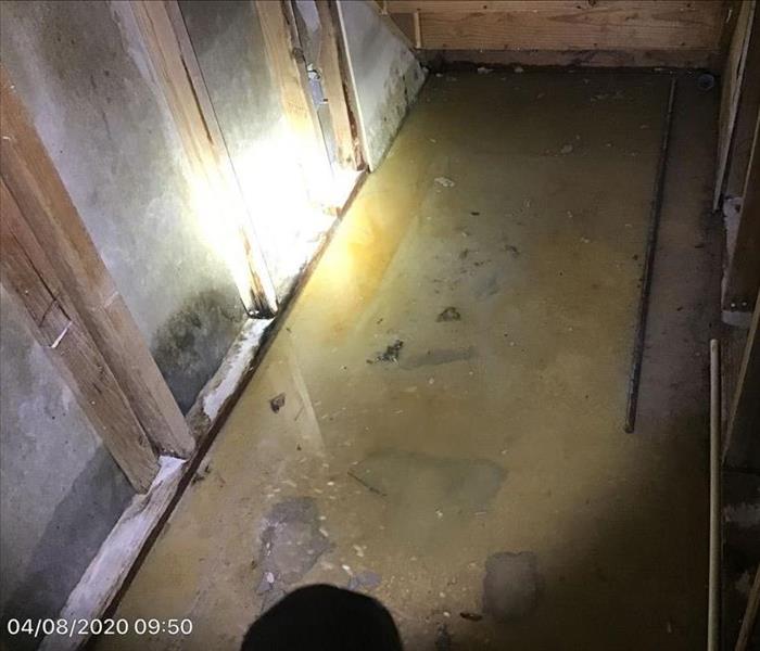 Standing water under a staircase