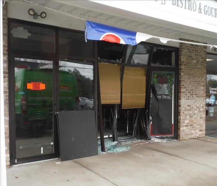 storefront of a shop with broken windows