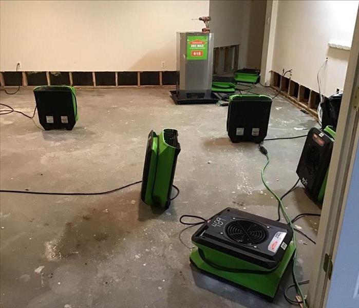 Drying equipment in a room after wet flooring was removed 