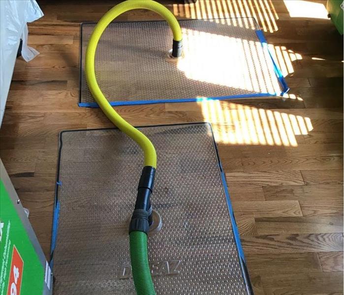 SERVPRO water extraction mats placed on a living room floor