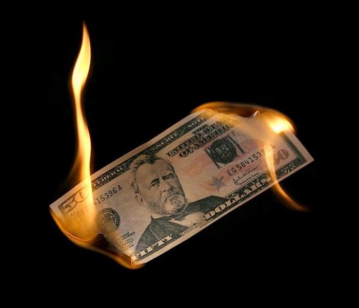 $50 bill burning on both ends